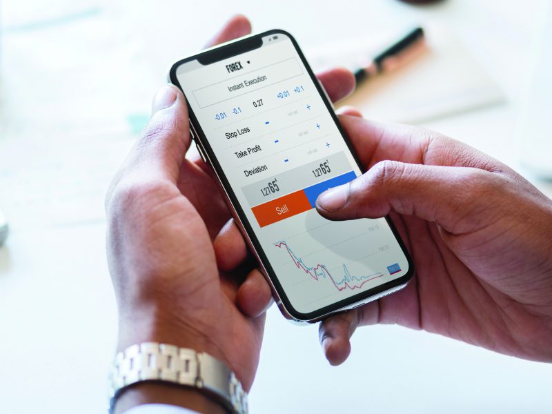 Lawyer tracking Forex currensy fluctuation on mobile smartphone